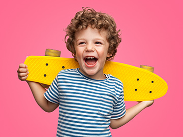lachendes Kind mit Skateboard